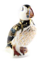 A Royal Crown Derby porcelain puffin paperweight, gold back stamp and red printed marks, boxed.