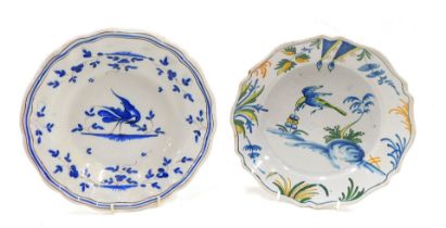 Two French Faience pottery plates, one decorated with a bird, in polychrome colours, 22cm diameter.