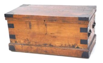 A late 19th/early 20thC elm and ebonised metal chest, the hinged top enclosing a vacant interior, wi
