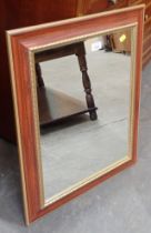 A reproduction rectangular wall mirror, with brushed wood finish and gilt border.