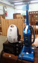 A Hoover whirlwind 250 air watts vacuum cleaner, a microwave, and an Argos vacuum cleaner. (3)