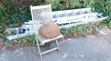 A folding garden chair, wicker hanging basket, and various ladders to include step ladder, extending