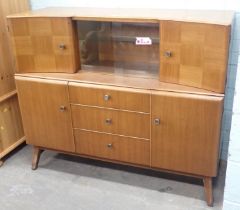 A teak sideboard, with two cupboard section and slide door above arrangement of three drawers and tw