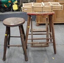 Two wooden stools and a folding wine rack.