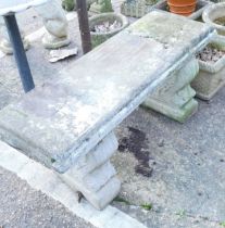 A reconstituted stone garden bench.