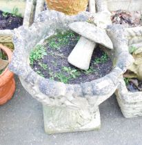 A reconstituted stone garden urn with fluted border, and a toad on toadstool ornament. (2)
