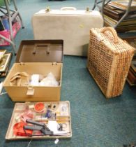 A wicker basket, travel case and a sewing box.