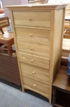 A beech finish tall chest of six drawers.