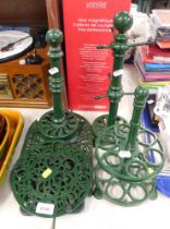 A group of cast kitchen wares, comprising mug stand, kitchen roll holder, pan trivets, and an