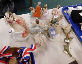 A collection of ceramic ladies and a Capodimonte flower.