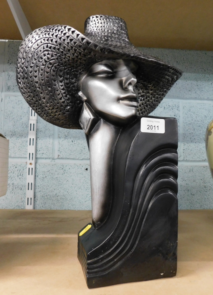 An Art Deco style book end, formed as a lady in silvered cap on black base.