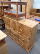 A pine sideboard, with cupboard top above six drawers, on block base, and a reproduction coffee tabl