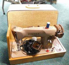 A cased Singer sewing machine.