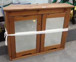 A pine two door cabinet.