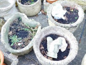 Various reconstituted stone garden planters, comprising a pair with fluted borders, squirrel and chi