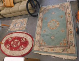 Two Chinese wool cut rugs, comprising a red oval example, and a turquoise and floral rectangular exa