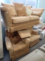 A terracotta coloured drop arm two seater sofa and two associated armchairs, and a box stool. The up