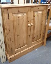 A pine two door cupboard.