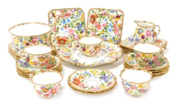 An early 20thC Hammersley porcelain part tea service, painted all over with flowers, gilt heightened