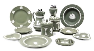 A group of Wedgwood green Jasperware, including jars and covers, table lighters, thimbles, plates an