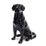 A Beswick pottery fireside figure of a black labrador, modelled seated, number 2314, 33.5cm high.