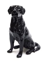 A Beswick pottery fireside figure of a black labrador, modelled seated, number 2314, 33.5cm high.