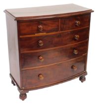 A Victorian mahogany bow front chest, of two short over three long graduated drawers, raised on turn