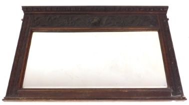 A Victorian carved oak over mantel mirror, the pediment with leaf carving, over a frieze with a lion