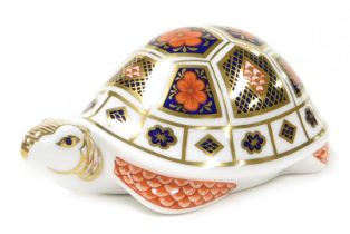 A Royal Crown Derby Imari tortoise paperweight, gold stopper.