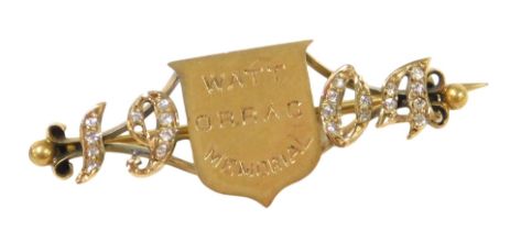 An Edwardian 18ct gold and diamond brooch, of equestrian interest, the central shield engraved Watt