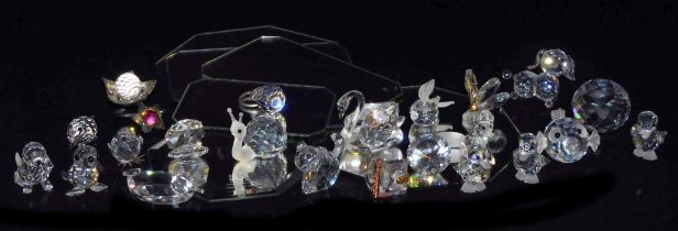 A group of Swarovski and other crystal figures, including dogs, baby seal, puffer fish, fox, cat and