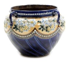 A late 19thC Doulton Lambeth stoneware jardiniere, of four handled semi fluted form, decorated with