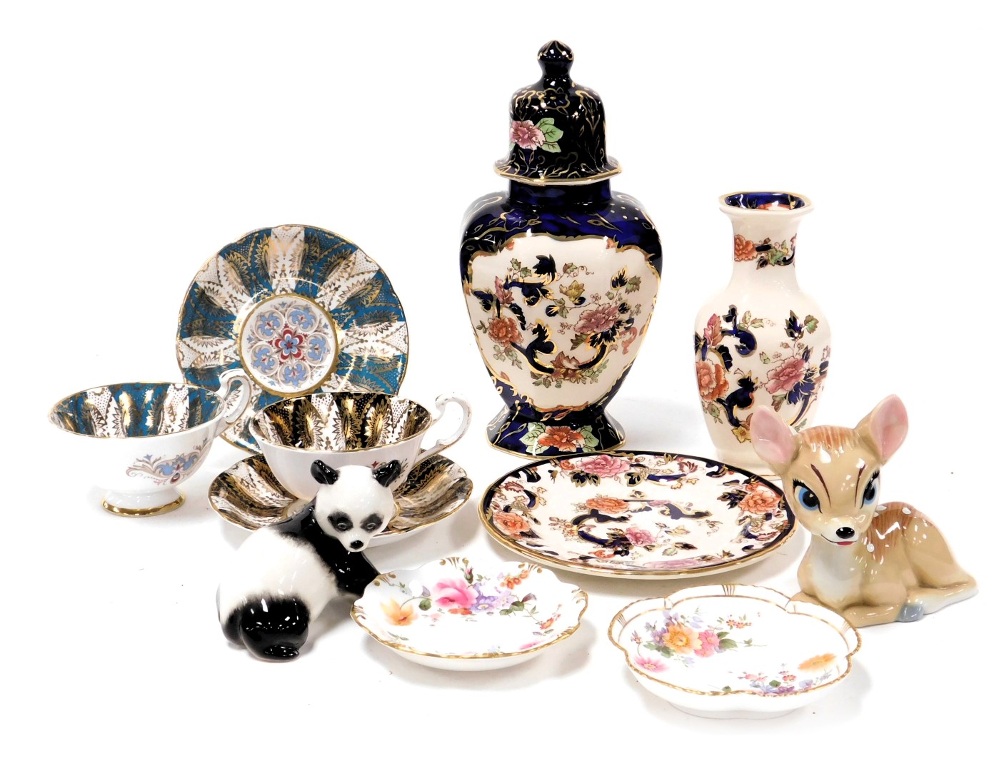 A group of ceramics, including a pair of Paragon porcelain tea cups and saucers, Wade blow up figure