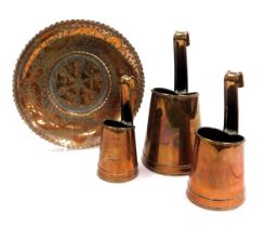 Three early 20thC copper dairy measures, engraved for Trent Dairies, together with a copper dish wit