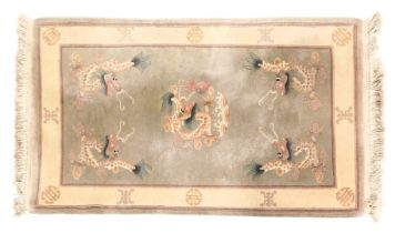 A Chinese grey ground rug, decorated with dragons chasing flaming pearls, within a cream border, 158