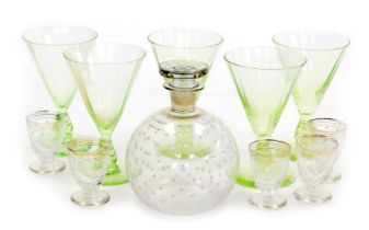 An early 20thC continental glass liqueur set, with a decanter decorated with white enamelled jewelli