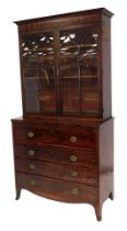 A George III mahogany secretaire bookcase, the upper section with a moulded cornice, raised above tw