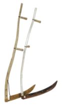 A wooden handled scythe, 165cm wide, and a metal handled scythe, 145cm wide.