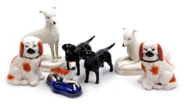 Two Beswick pottery figures of black labradors, a porcelain Staffordshire style inkwell modelled wit