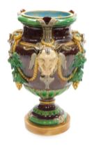 A late 19thC majolica vase, probably Minton, of baluster form, moulded with Bacchanalian masks, vine