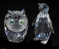 A Swarovski crystal figure of a penguin, 8.5cm high, together with an owl. (2)