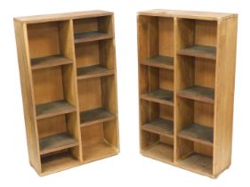 A pair of mid-century oak free standing shelves, of rectangular section, with six staggered shelves