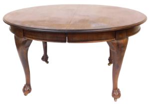 A Victorian mahogany extending dining table, the oval moulded top raised on four ball and claw feet,