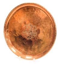 Hugh Wallace (1871-1944). A circular copper salver, with central engraved foliate decoration, squar