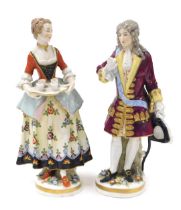 A pair of late 19thC Vienna style porcelain figures, of a gallant, and a lady offering refreshments