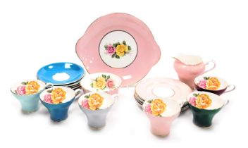 An Aynsley porcelain harlequin part tea service, decorated with roses, comprising cream jug and suga