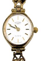 A Rotary lady's 9ct gold cased wristwatch, oval textured silvered dial, on a bracelet strap, boxed,