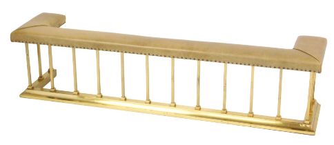 A Victorian style club fender, with leatherette top, raised on vertical brass bars with a plain D en