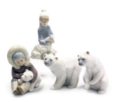 Four Lladro porcelain figures, comprising a a kneeling boy with a lamb, Eskimo boy with a polar bear