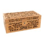 A late 19thC Chinese wooden box, of rectangular section, profusely carved with figures in a garden,